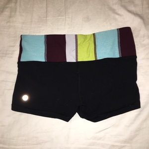 Black booty shorts with a design at the waist